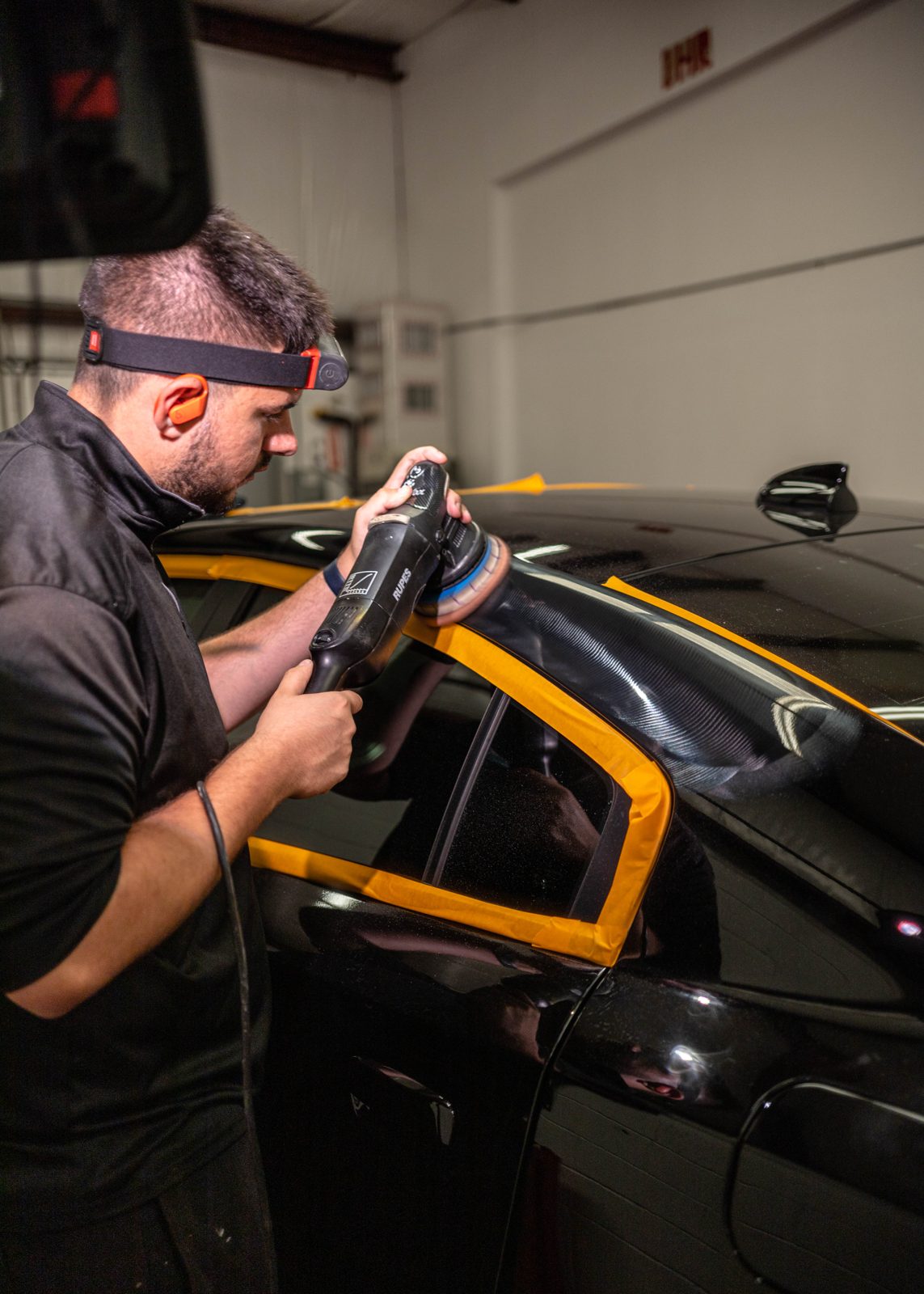 Obsidian detailer applying paint protection film to a hood in Towson