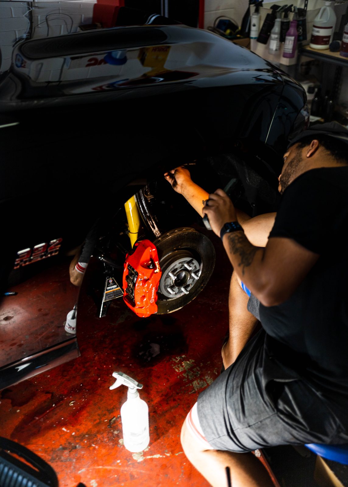 Obsidian detailer cleaning an engine bay during a mobile detail in Baltimore