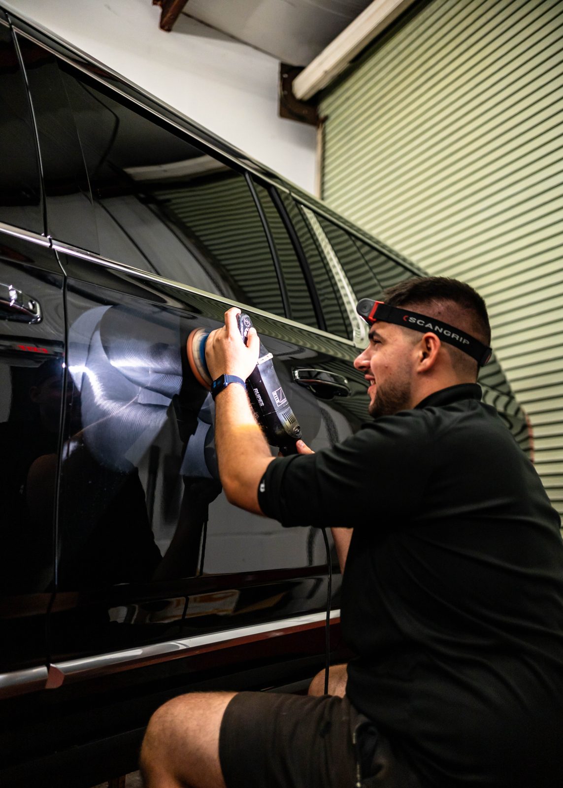 Obsidian tech deep-cleaning the interior of a black car in Towson